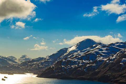 A panoramic view of boats passing through Dutch Harbor