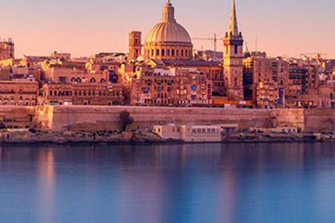 The sun rising over Valletta