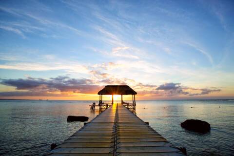 Jetty silhouette against beautiful sunset in Mauritius Island